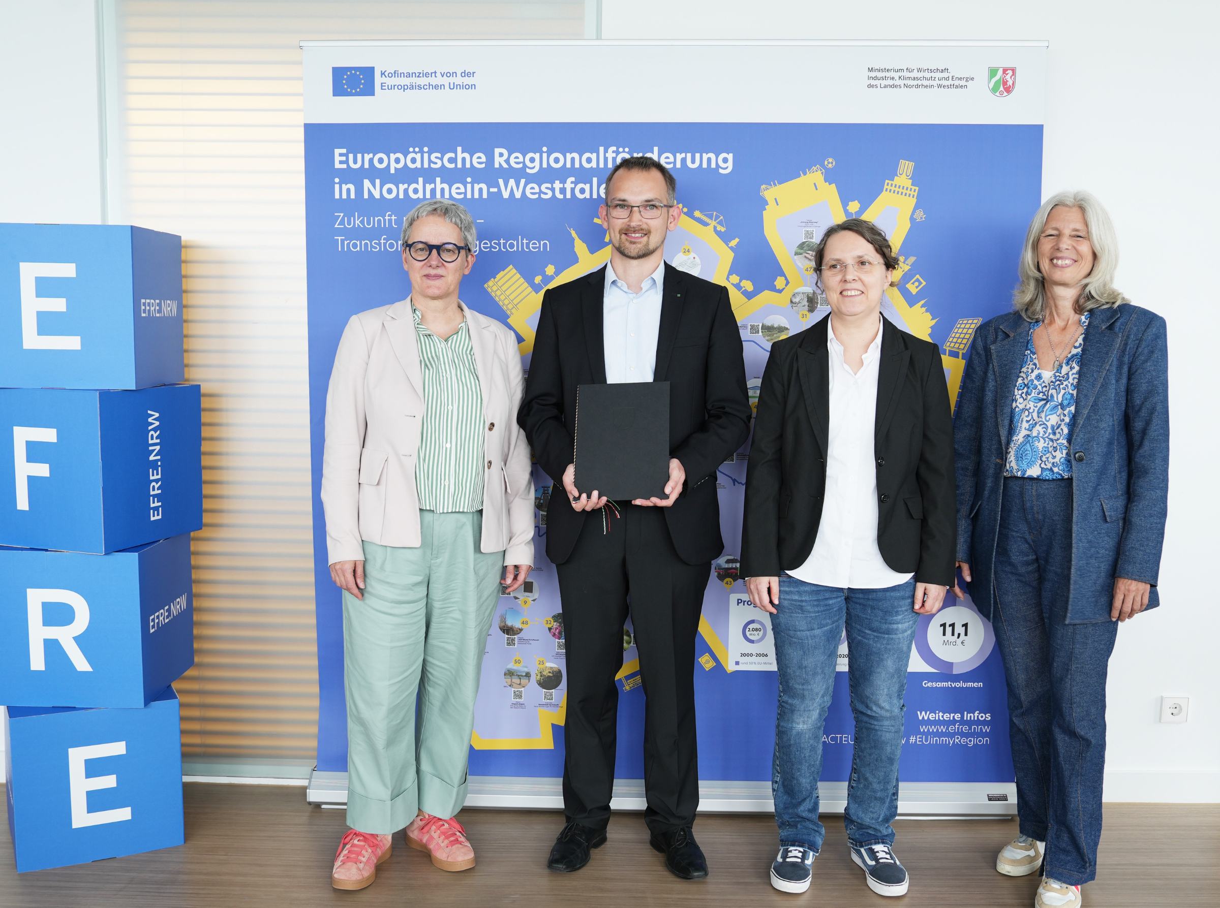 Gruppenfoto_Efficynet Vier Personen auf einem Foto.