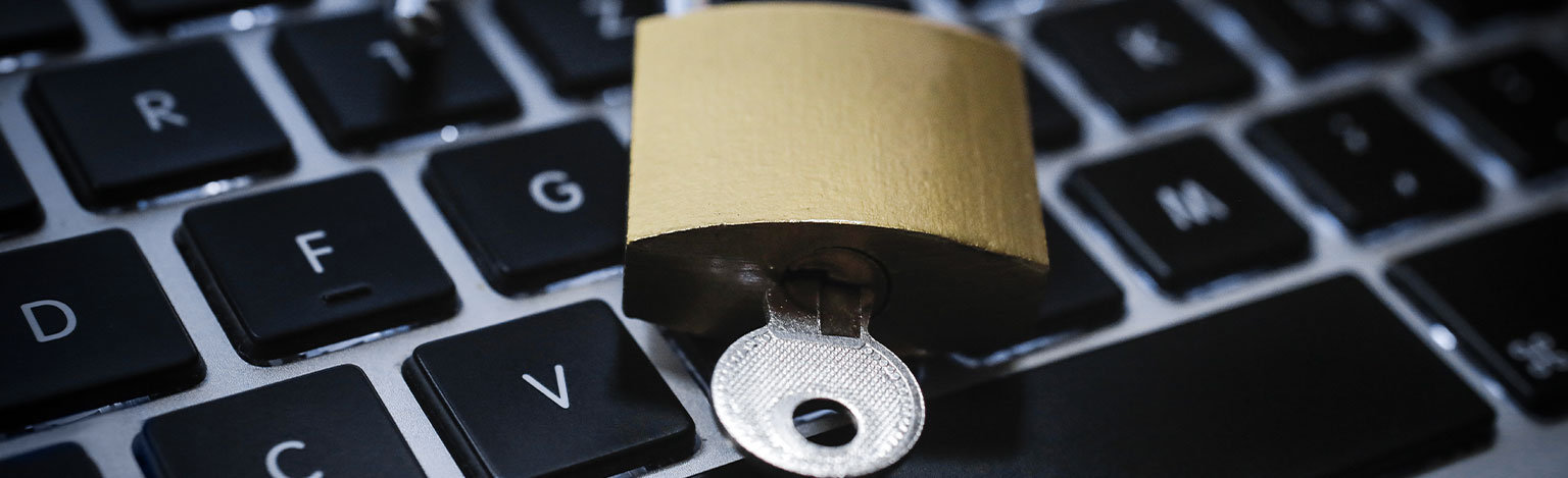 An open lock lies on a keyboard