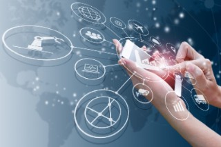 Two hands hold a mobile phone with several icons emanating from its screen.